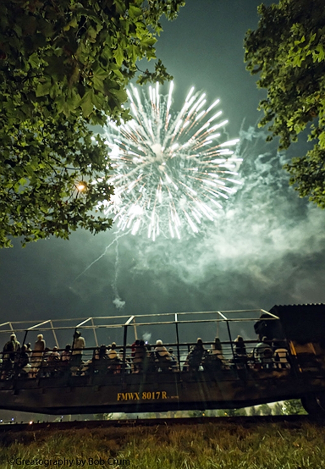 (Above) Folks on the Fillmore & Western open air cars enjoy the Fillmore fireworks show from front row seats. 

Story and photos by Bob Crum.

If memory of history serves correctly... it was way, way, way back on July 2, 1776, that the members of the Continental Congress meeting in Philadelphia undertook the bold (and dangerous) vote for independence from Great Britain. But... it wasn't until the 4th of July that they formally adopted the paramount document that we know as of the Declaration of Independence. The event was cause for great celebration throughout the land and the people of the United States of America have been celebrating ever since. 

When it comes to hosting a great July 4th party, Fillmore... the last best small town in Southern California... knows a thing or two about serving up a magnificent banquet of good times. The recipe: a batch of fireworks booths... add a heaping supply of gorgeous restored classic cars, vendors serving yummy goodies... unlimited shaved-ice cones... music to massage the ear drums and a majestic steam engine that never fails to enthrall the multitudes within hearing distance of her magical steam whistle.

Serving a feast of this magnitude... who wouldn't want to come? So they did. By the gazillions. You were there... right? Throngs of people ogled the many beautifully restored antique classic cars. Some folks were seen drooling excessively while others simply fell madly in love with the classic car of their dreams... and wishing. Many others were exercising their mouth muscles by munching on a tasty morsel of choice. Many also stopped by the hat booth and bought a sombrero to shield them from the blazing hot sun? The day was indeed a scorcher. 

When tired feet needed a reprieve, rest for the weary was on one of three scheduled trains pulled by Fillmore & Western Railways' mighty Baldwin #14 steam locomotive as she whisked delighted passengers on a thrill-of-a-lifetime trip through the beautiful Fillmore countryside. OK... it wasn't quite bullet-train speed but traversing Fillmore's bucolic terrain at unhurried steam locomotive speeds manifests melancholy. Remember how sweet were the good old days of leisurely travel?

Steam engine aficionados not riding the train were chasing me chasing the train to catch a photo... or twenty. More is not even enough. Admittedly... no sooner than I hear the steam engine's whistle I'm afflicted with POCD... Photographic Obsessive Compulsive Disorder. An incurable malady. However... grabbing the camera and shooting a few photographs provides some measure of temporary relief. Very temporary!

As the sun disappeared below the western horizon... a wonderful day of fun and good cheer was topped off with a fabulous display of fireworks. As a visual tribute... and a brief reminder of our independence as a country... the Fillmore's fireworks show did not disappoint.

It was a fabulous banquet of good times! Now, however, torturous will be the 362 days waiting for the next July 4th festivities. Oh... if only we had a time machine!

Congratulations to all the people who executed the many tasks that made the day of celebration great, as well as memorable, for all who partook of the fabulous festivities. A job well done!