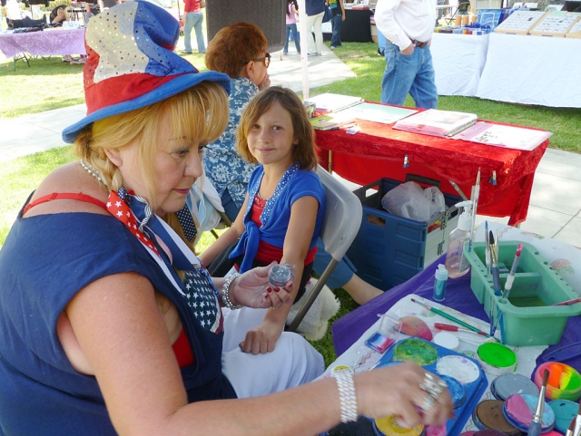 Lindsey was happy to get a face-painting on her arm Sunday. The crowd was filled with children with face paintings.