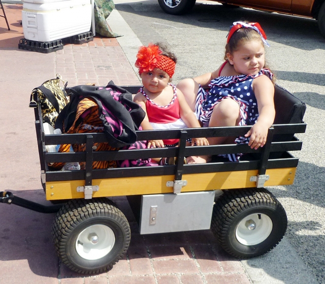 Showing off their own wheels, these two cuties just sat back and enjoyed the 4th of July Car Show from their own perspective.