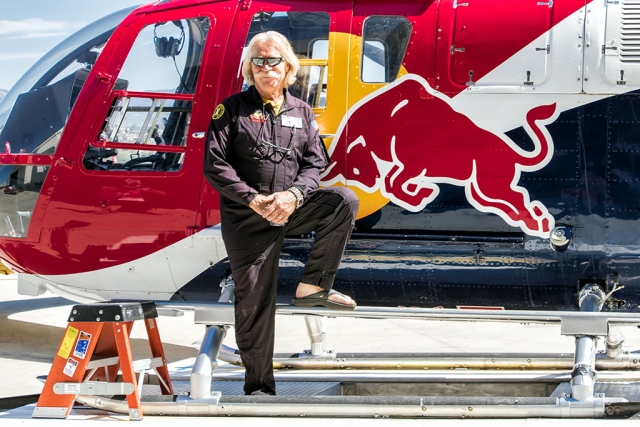 Aerobatic helicopter daredevil Chuck Aaron in front of his Red Bull chopper. Aaron is retiring from a long successful career. Photo courtesy Bob Crum.