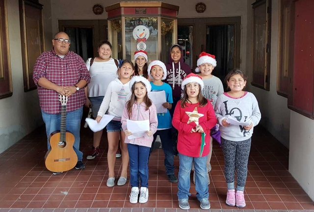 Friday afternoon a group of kids from the Boys & Girls Club got into the Christmas spirit, by singing Christmas Carols to the community in front of the Historic Fillmore Town Theatre.