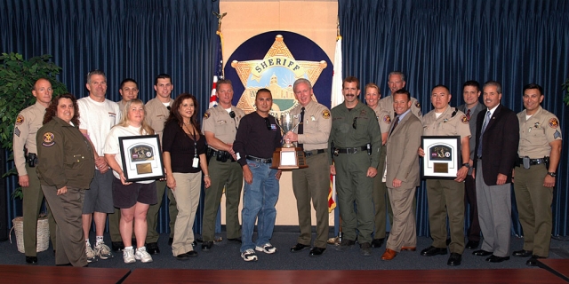 Baker to Vegas team members and volunteers presenting the trophy to Sheriff Brooks.