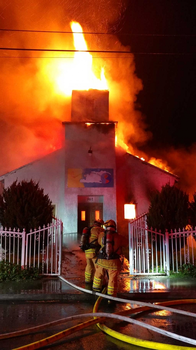 At approximately 4:50 a.m. Sunday, the Fillmore Fire Department received a structure fire call. Arriving at the Christian Evangelical Church, 900 block of Third Street, the Department found the steeple fully engulfed in flames. Fillmore Fire, Ventura County, and Santa Paula Fire battled the blaze for about an hour. The structure was a complete loss after the steeple collapsed into the main structure. A family of six was reported to have escaped without injury. The cause of the fire is under investigation. Fire photos and videos courtesy of Sebastian Ramirez