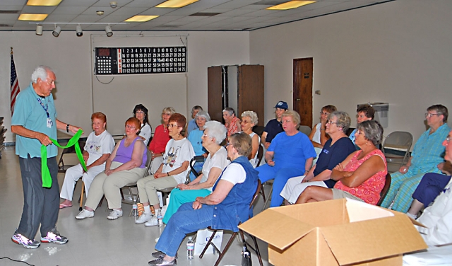 Bob McCullagh, certified instructor and senior advocate with the SCAN Senior Resource Center, demonstrates a stretch technique at the Fillmore Senior Center.