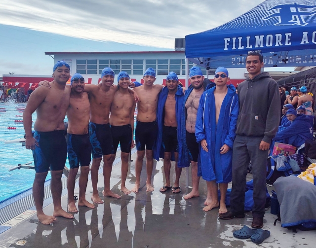Pictured from left to right are Flashes Alex Diaz, Jessie Cavazos (Varsity), Ulysses Garcia (Varsity), Nicko Garcia (Varsity), Emiliano Castanon, Tony Aiden Asfour, Bradley Villa, and Coach Matthew Tello after their victory in their swim meet against Hueneme High School. Photo credit FHS Swim Coach Hannah Faith.