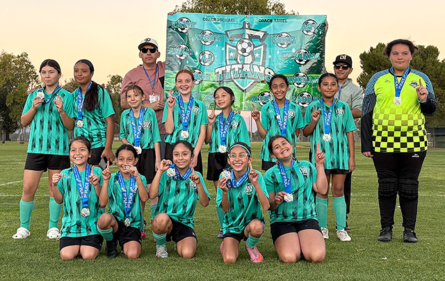 On December 6-7, Fillmore 12U Girls Soccer Team competed and won the Area 10W Playoff Championship Game, which moves them to the next game to take place in Bakersfield in February. Top row (l-r): Breanna Lane, Daniella Solis, Amairany Lizarraga, AJ Aguilar, Sierra May, Aleeah Suarez, Anahi Juarez, and Ary Williams. Bottom row (l-r): Emmy Ceballos, Audree Valenzuela, Sofia Casimiro, Avery Chavez, and Sarah Sasson. To the left: Coach Angel Chavez and to the right, Coach Michael Ceballos. Photo credit Alyssa Ceballos.