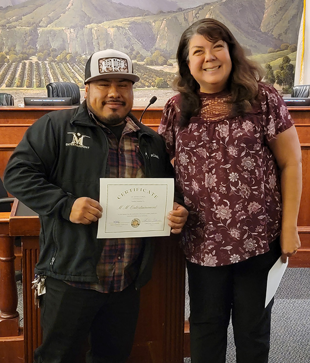 Pictured is Jose from MM Entertainment with former Mayor Christina Villaseñor who was also present for recognition for sponsorship and coordination of music and snow at the Fillmore Tree Lighting.
