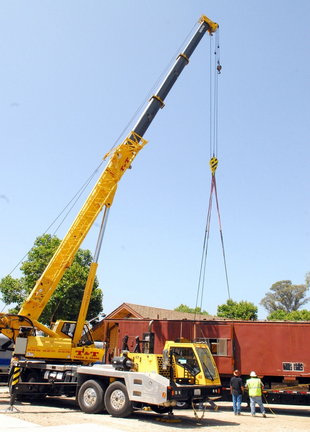 Wednesday, June 16, The Fillmore Historical Museum, moved a caboose from Bud Lowe’s property in Hopper Canyon. T and T Crane Company removed the caboose from the flatbed and lowered it to a piece of track next to the depot.