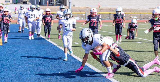On Saturday, October 17, the Fillmore Raiders Bantams, Sophomores and Juniors hosted home games. Pictured above, a Raiders Sophomore dives into the end zone to score against the Oxnard Warriors. The Raiders defeated the Warriors, 30-0. Pictured below, a Raiders Bantam player takes down a Simi Valley Bulldogs player during their matchup. The Bantams fell to the Bulldogs, 44-8. Photo credit Crystal Gurrola.