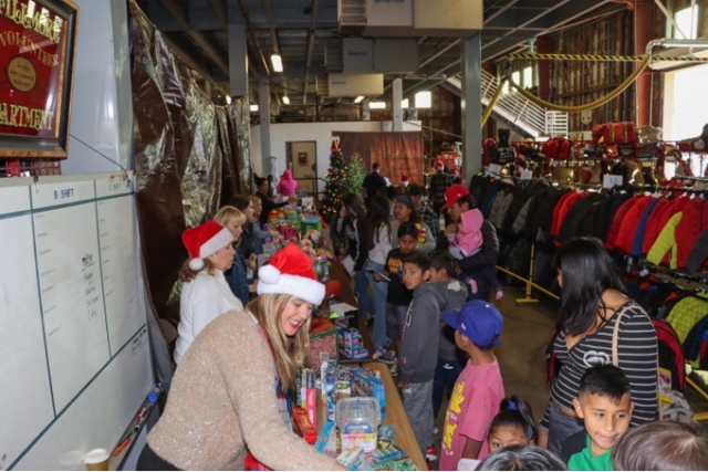 On Saturday, December 16, 2023, the Fillmore City Fire Station was jam packed with kids lining up out the door for the Annual Fillmore Community Holiday Giveaway! Each child who resides within FUSD was given a new toy and reading book, a new coat and socks, holiday bags of groceries, as well as a limited number of Christmas trees. As folks waited in line Santa greeted them and posed for photos, celebrating Christmas cheer! Annual sponsors of the event include our local Fillmore Police and Fire Departments, Santa Clara Valley Legal Aid, One Step A La Vez, Soroptimist International of Fillmore, Saint Francis of Assisi Church, Fillmore Future Farmers of America, Sespe 4-H, Rotary International of Fillmore, Fillmore Lions Club, Ventura County Deputy Sheriff’s Association, the Sheriff’s Mounted Posse, Fillmore Citizen’s Patrol, Fillmore Search and Rescue, Fillmore Friends of the Library, Fillmore Women’s Service Club, Lightfully Behavior Health, the Salvation Army, Balden Ranch, Allied Citrus & Fruit, Villasenor Enterprises, the Fillmore Fire Foundation and numerous other generous personal and business donors. Photo credit Angel Esquivel-AE News. 