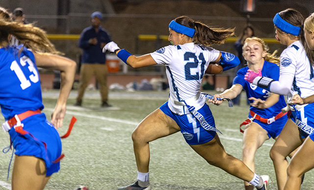On Thursday, September 17, the Fillmore Flashes girls flag football team took the field against Cate High School. Above, Flashes #21 carries the ball past the Cate defense, picking up valuable yards for Fillmore. Below, Flashes #24 pulls the flag of a Cate player during Thursday’s game. Fillmore defeated Cate High School, 32–0. Photo credit Crystal Gurrola. 