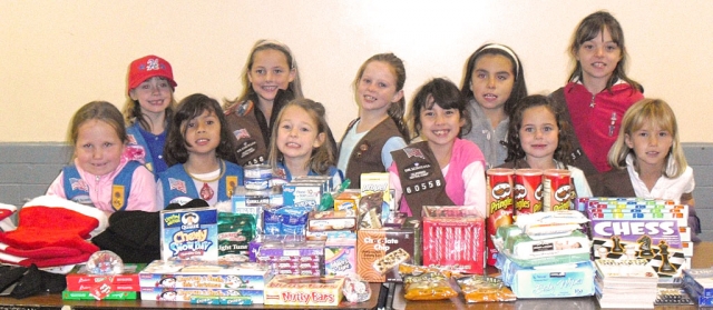 Girl Scout Troops 60558 and 60420 from Fillmore collected goodies to fill Christmas stockings for soldiers in Afghanistan. The girls from back left, Ashlan Larson, Natalie Couse, Kylene Sampson, Ari Schieferle, Katie Berger, Emma Myers, Bella Ibarra, Sydney Beckett, Natalie Parrish, Kirah Sampson and Kate Johnson made Christmas cards and stuffed 21 stockings with candy, puzzle books, beanies, batteries, chips, and trail mix. Leaders Kelli Couse, Casey Beckett and Paige Lenee want to thank everyone who donated.