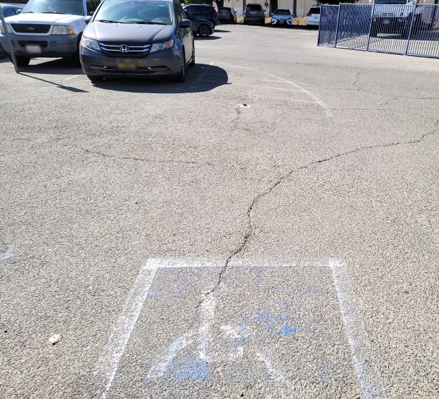 The main parking lot adjacent to the police department is in need of immediate maintenance. Frequent requests to have this handicap parking area restored have been unsuccessful. The pole sign was destroyed about a year ago and the painted designation is mostly worn away from frequent traffic. The city is, once again, asked to restore the sign and re-paint the pavement. 