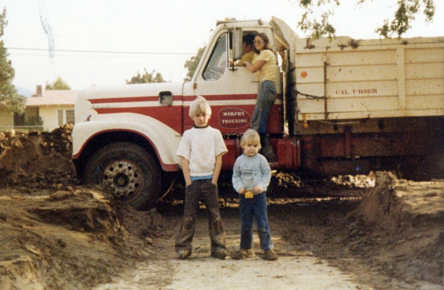 Residential driveway at Highway 126 & Rhodes Ct. (Hwy 126 runs left to right in the background). Scott & Kellie Duckett enjoying a break from cleaning up mud. Not sure what the child labor laws were like in 1978 but this picture proves we were allowed to take at least one break.