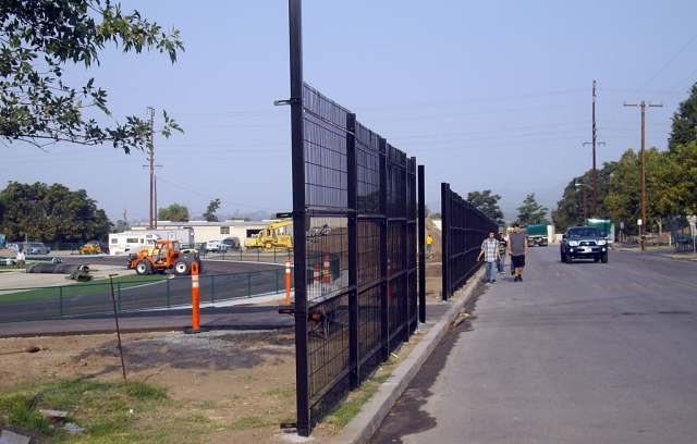 A steel fence gone up at the north end of the track field on Second Street. The fence, just inches from the curb, will present a challenge to parked car doors opening and to pedestrians forced to walk in the street as shown above.