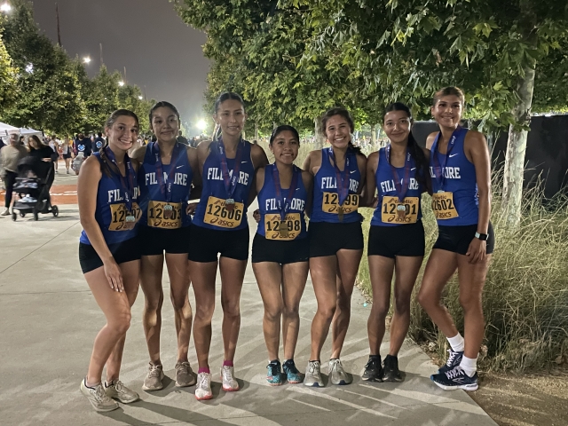 On Friday, September 15, Fillmore Flashes Cross Country team competed at the Woodbridge Invitational at Silver Lakes Sports Complex in Irvine. Both boys and girls teams ran well, placing in multiple races. Pictured is the Girls Varsity team which placed 4th and was awarded medals. Pictured (l-r): Leah Barragan, Diana Santa Rosa, Nataly Vigil, Niza Laureano, Alexandra Martinez, Jessica Orozco and Joseline Orozco. Photo credit Kim Tafoya.