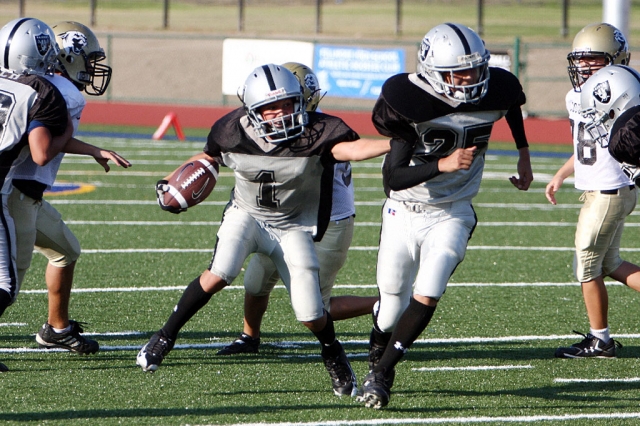 Chad Hansen follows Alex Banales through a hole in the defense.