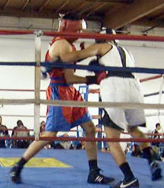 Jonathan (red jersey) delivers a right uppercut to the body of his opponent.