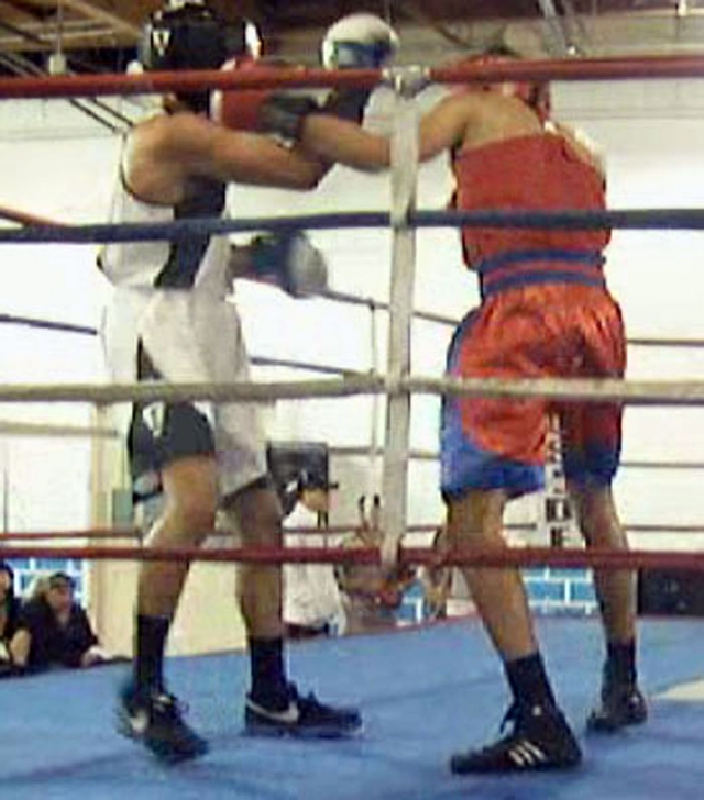 Jonathan (red jersey) backs up his opponent with a left hook.