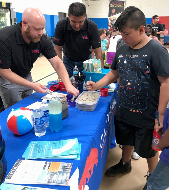 Engineers from California Resources Corporation interact with youth about STEM activities and careers in STEM. Photo provided by: California Resources Corporation.