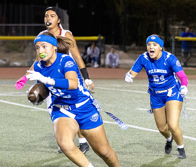 On Tuesday, October 13, the Fillmore High School (FHS) Flashes Girls JV and Varsity Flag Football teams faced longtime rival Santa Paula High School while celebrating Senior Night. Pictured above, a Varsity Flashes player works her way past the Cardinals’ defense. The Varsity team fell to Santa Paula, 32-0. Photo credit Crystal Gurrola.