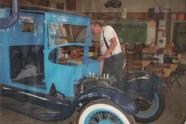 Above is the Great American Race 1920 Model A restored in 1999 in the Fillmore Christmas Parade, Inset, Lin Thomas working on the Model A as it is being restored. Photo credit Fillmore Historical Museum.