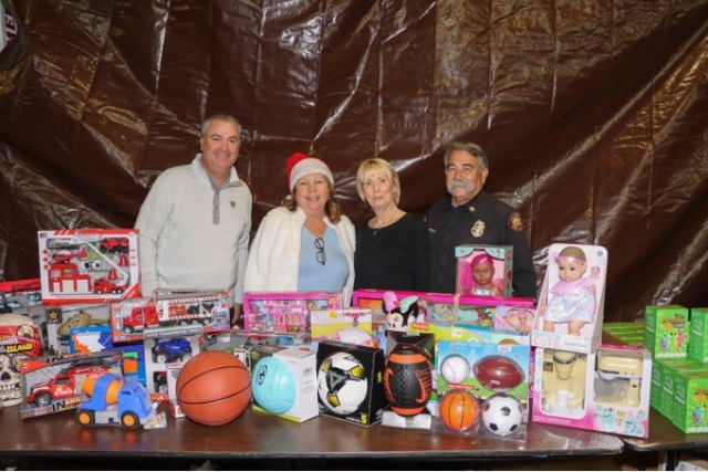 On Friday, December 15, at the Fillmore Fire Station, a Holiday Giveaway was held for children with special needs and their families. The kids had their pictures taken with Santa Claus, as well as other fun activities while they collected their unwrapped toys. Pictured above is Fillmore City Manager Dave Rowlands, Fillmore Mayor Carrie Broggie, and Sandy Gurrola with her husband, Fillmore Fire Chief Keith Gurrola, who were in attendance and helped hand out toys. Pictured below is McGruff the Crime Stopping Dog and Fillmore Police Chief Eduardo Malagon. Photo credit Angel Esquivel-AE News.