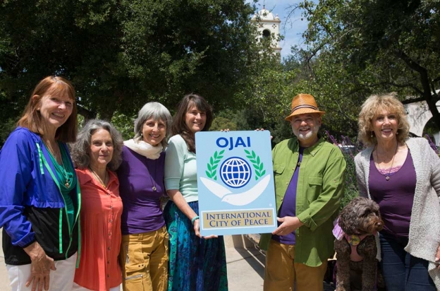 Peace Pod with Ojai Sign: Anahata Pomeroy, Julie Heyman, Lisa Berman, Kathy Nolan, Brian Berman, Dianne McCourtney, not present in photo Ray Powers and Sylvie Lee. Photo by David Baker. 