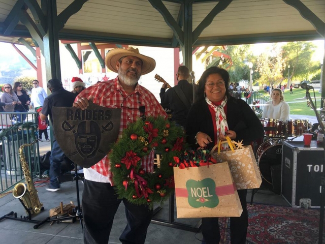 On Saturday, December 8th from 12pm – 6pm in downtown Piru the 41st Annual Piru Christmas Parade and Festival was held. They had music, Santa, booths and more! This year’s Grand Marshal’s were Tomas and JoAnn Torres pictured below after the parade with a wreath from Marlenes Flowers, Raider shield, candle holder from @carbun_design, and a blanket from Faith Lugo. Photos courtesy Piru Neighborhood Council Facebook page.