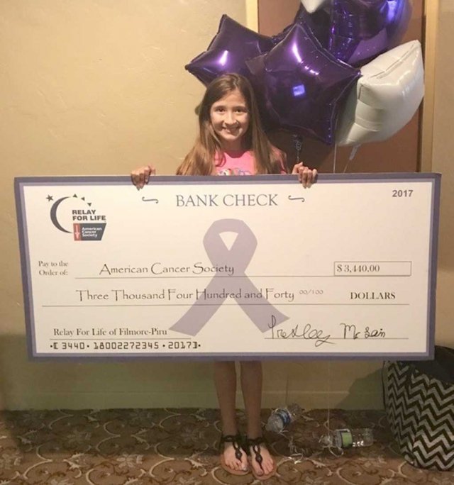 Fillmore’s Presley McLain standing with a donation check for $3,440 for this year’s Relay for Life of Fillmore-Piru.