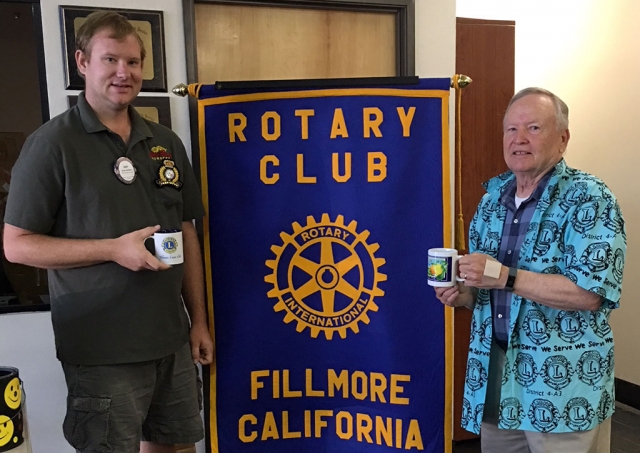 (l-r) Rotary Club President Andy Klittich and Scott Lee, former Mayor of Fillmore and President of Fillmore Lions Club and the Bardsdale Cemetery Board, guest speaker at this week’s Rotary Club meeting. Since the Rotary and Lions are friendly rivals and joke a lot Scott presented Andy with a Lions mug, wearing his Lions shirt and Andy presented Scott with a Rotary mug, wearing his Rotary shirt. Photo courtesy Martha Richardson.