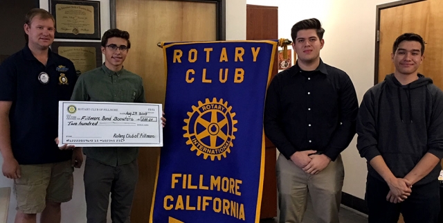 Fillmore Rotary Club President Andy Klittich presented a donation check of $200 to the Fillmore High School Band Boosters. Receiving the check on behalf of the club are FHS Band members George, Damian and Jerry. Photo courtesy Martha Richardson.