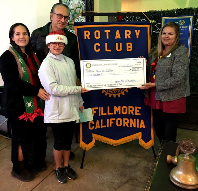 Pictured is Reverend George Golden, with the assistance of his family members, Vanessa and Hannah, joining Fillmore Rotary Club last week. Courtesy Martha Richardson.