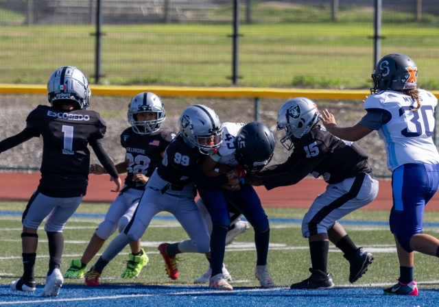 Pictured is a group of Raiders Freshman teaming up and take down a Camarillo player to keep him from advancing up the field. Photo credit Crystal Gurrola.