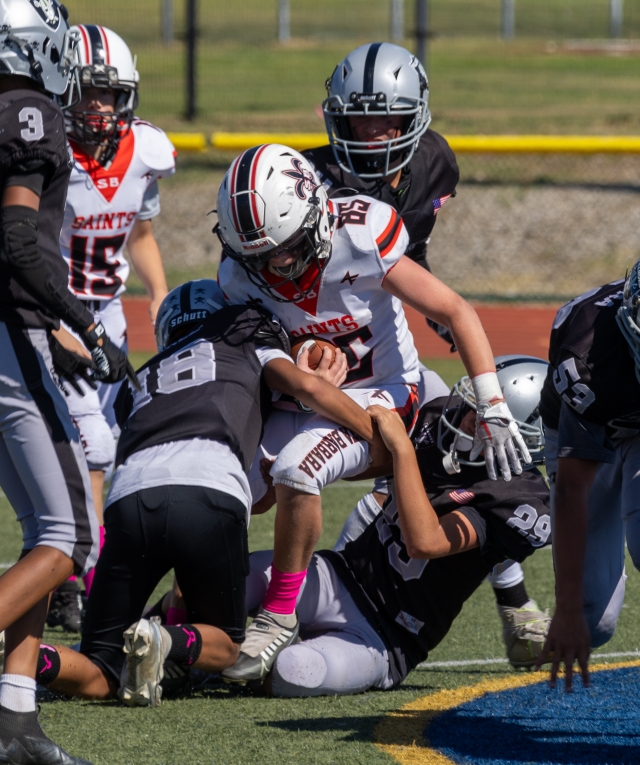 Pictured is a group of Raiders Juniors taking down a Saints player during last Saturday’s game. Photo credit Crystal Gurrola. More photos online at www.FillmoreGazette.com.