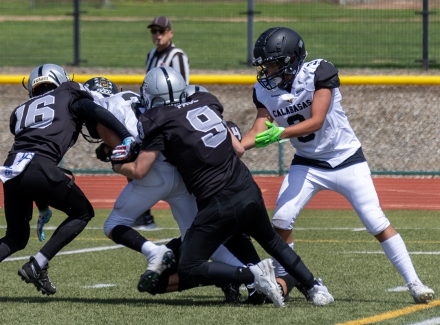 Raider Seniors #16 & #9 take down a Calabasas player in last Saturday’s game. Photo credit Crystal Gurrola.