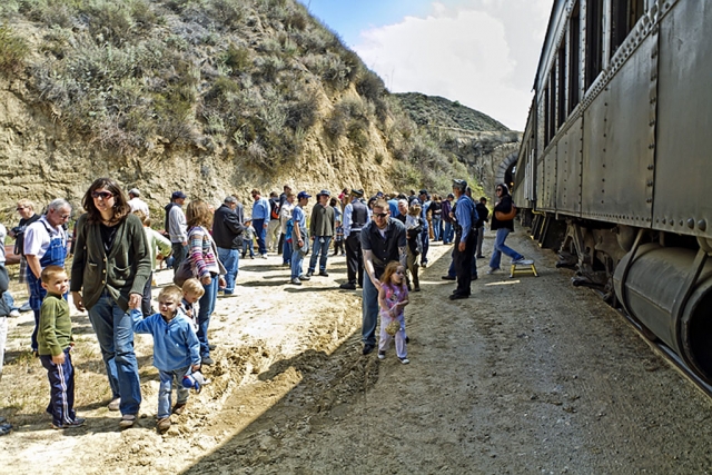 People disembark to be able to photograph the train bursting out from the tunnel and speeding by. Often characterized as a photo op.
