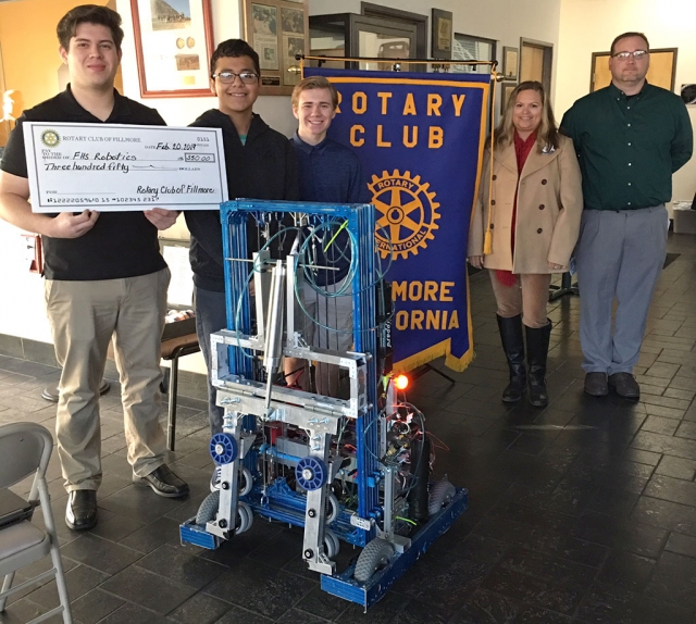 Fillmore Rotary Club presented a check for $350 to the FHS Robotics team. Pictured (l-r) is Damian, Jesus, Matt, Pres.-Elect Ari Larson, Mr. McMahan and some of the students from the FHS Robotics team. The team brought their latest project to share with the club. They also shared that they are preparing to compete at Ventura College with teams from around the world. Photo courtesy Martha Richardson.