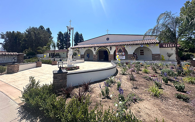 Saint Francis of Assisi Roman Catholic Church held their Centenary Celebration on Sunday, July 19, 2026.  The church also revealed its new “California Mission” look, pictured right. The building was dedicated on February 1, 1976. In 1914 Fillmore was a mission of St. Sebastian Parish in Santa Paula, ten miles west of Fillmore. The priests from Santa Paula offered Holy Mass in backyards and classrooms and helped the small but growing number of Catholics raise funds through fiestas, bazaars and raffles. In 1924 they petitioned Bishop John J. Cantwell to supply a priest and church for Fillmore. The bishop had a great concern for the spiritual welfare of his people. Over a period of 30 years, Bishop Cantwell created 50 parishes and missions as the seventh Bishop of the Diocese of Los Angeles and San Diego. In 1926, by God’s grace, the tiny church located at the corner of First Street and Central Avenue in Fillmore was one of them, serving the community as a beacon of faith. Numerous baptisms, weddings, funerals, confirmations and first communions were celebrated there, as well as daily and Sunday Mass for the growing number of the devout. Photo credit Gazette staff.