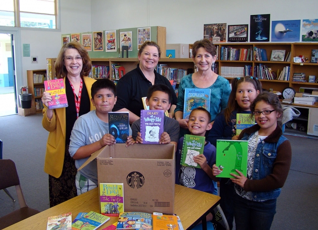 Starbucks and The Heart of America Foundation and its Books from the Heart program recently collected books at various Starbucks, to be placed in San Cayetano Elem. School's library. Pictured along with some of the excited students are Sheila Duckett, Library Clerk, Terri Collet-Sagner, Fillmore's Starbucks manager and Jan Lee, San Cayetano Principal. The Heart of America Foundation is a national nonprofit that promotes volunteer service and literacy.