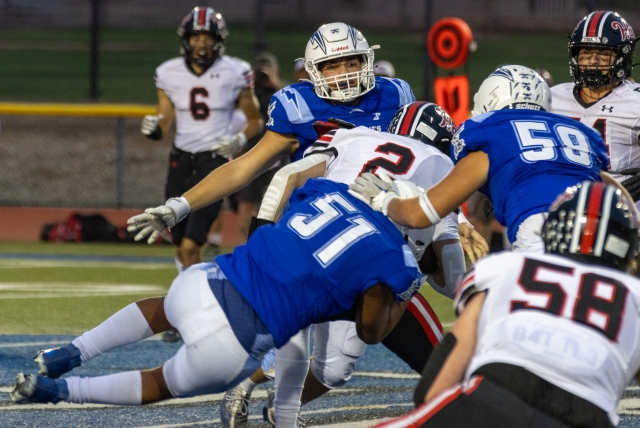 Pictured above is a group of Flashes Varsity players taking down a Hart player in last Friday’s game. Photo credit Crystal Gurrola. 