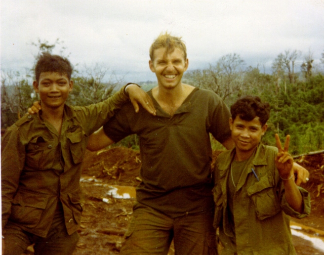 Theatre arts professor Michael J. Arndt poses with two Kit Carson Scouts in Vietnam in 1970.