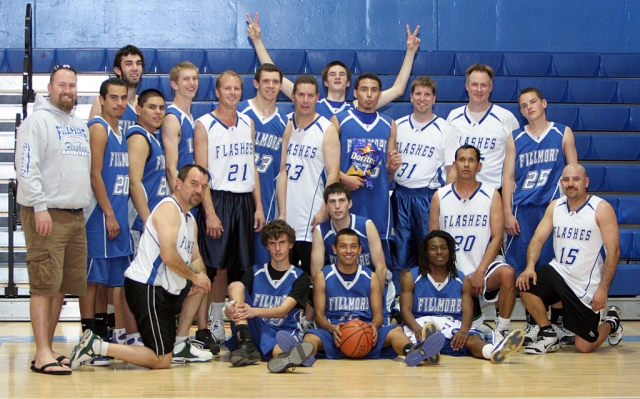 Above, players and alumni take a group photo after Saturday night’s game. Names were not available at press time.