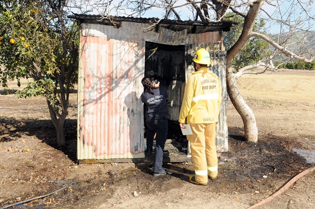 On March 17, at approximately 2:48 p.m., a structure fire was reported in the Bardsdale area, six units were on scene. Above an arson investigator takes pictures of the damage caused by the fire.