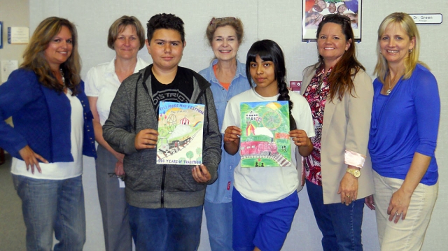 This year the public voted at the community awards dinner. Pictured are Fillmore Middle School Principal Ellen Green, Art Teacher Doris Nichols, Ari, Cindy & Tammy. Students in front, 2nd place went to Chris Medrano and 3rd place went to Vanessa Lopez. These two students will receive free entry to the Fillmore May Festival for all four days as well as carnival rides.