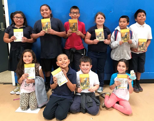 Students from the Boys & Girls Club of Santa Clara Valley smile for a photo with their recently donated art supplies from Michaels Arts & Crafts store in Ventura.