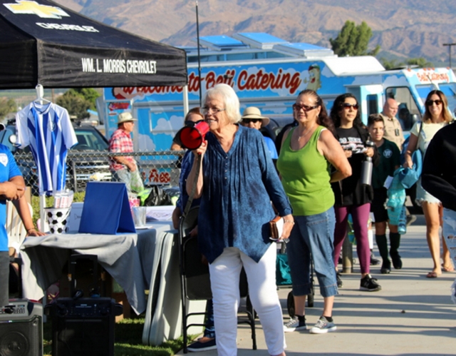 On Saturday, August 20th at Two Rivers Park, from 7:45 a.m. to noon, the community enjoyed Fillmore AYSO’s Season Kickoff Fundraiser celebrating their volunteers and benefiting their brand-new program, AYSO VIP, for children with special needs. Everyone who came out enjoyed great food, artisan and craft vendors, free photo booth, raffle and scavenger hunt. Above is Fillmore City Council’s Lynn Edmunds speaking at the fundraiser. Inset, some AYSO players in their game this past Saturday. Photo Credit Crystal Gurrola. 