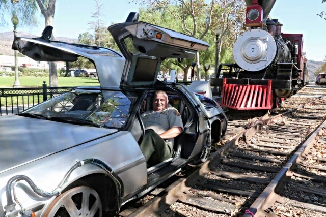 Fillmore Police Chief Dave Wareham went Back to the Future in the film’s classic DeLorean last weekend, during the Back to the Future Day celebration, marking the movie’s 30 year anniversary. Film crews were stationed at Fillmore’s Sheriff Station a week in advance of the occasion. For a donation to the Michael J. Fox Foundation for Parkinson’s Research, fans could ride in the DeLorean, which was retrofitted to ride back and forth on the train rails at Central Park. Fans were also able to glide across the park on a hoverboard suspended for a crane, for the price of $200 a ticket. A screening of the classic film was presented at the Fillmore Towne Theatre, while a Hill Valley sign welcomed the visitors to the event. Several downtown shops were transformed into the 1980’s townsquare where Marty McFly lived out his adventure. Photo courtesy Sebastian Ramirez.