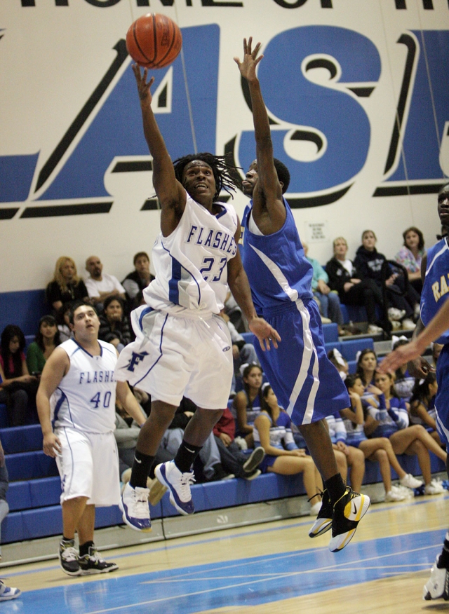 Troy Hayes #23 jumps past the defense for a two point lay up, against the Channel Island Raiders.