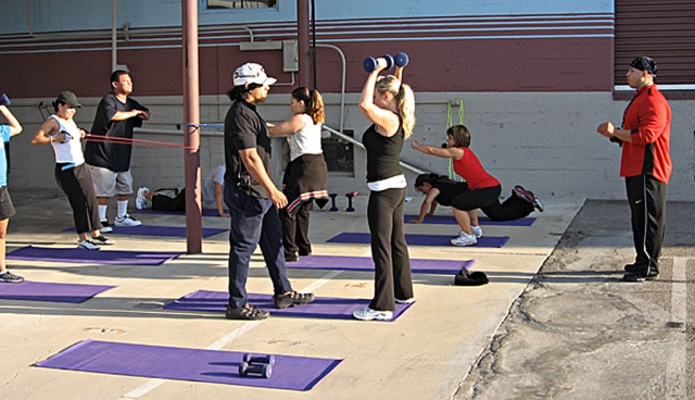 Round three of the Fillmore Fitness Project (Fitness Boot Camp) was held at A Street Storage Friday, July 4, 2008. (Above) Everybody was working hard at getting fit as Fitness Project Director Ivan Chavez corrects form, with Assistant Director Marcos Zuniga (far right) watching carefully. 